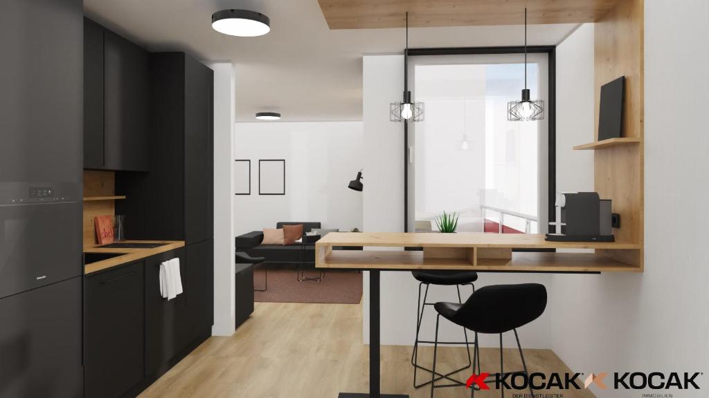 una cucina con tavolo e 2 sgabelli neri di KOCAK - Exklusives Apartment im Zentrum a Reutlingen