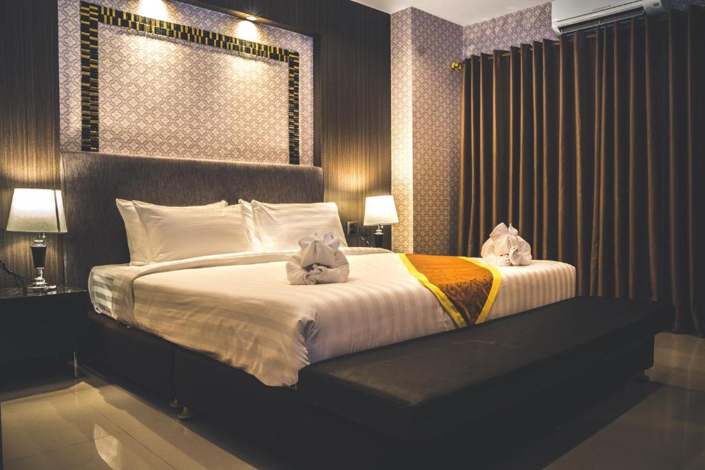 Postel nebo postele na pokoji v ubytování CK Resort Pattaya