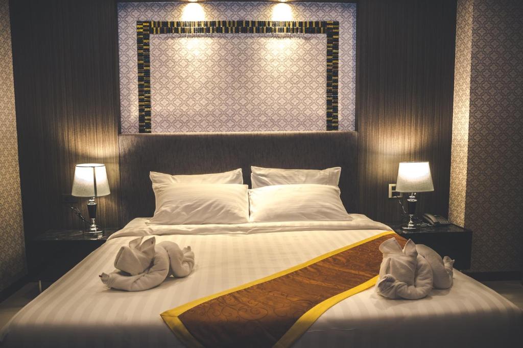 Postel nebo postele na pokoji v ubytování CK Resort Pattaya