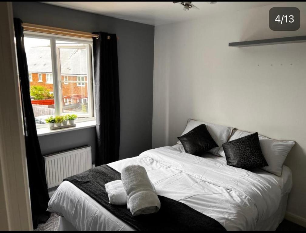 a bedroom with a bed with towels on it at Charming 3-Bed House in Gloucester in Gloucester