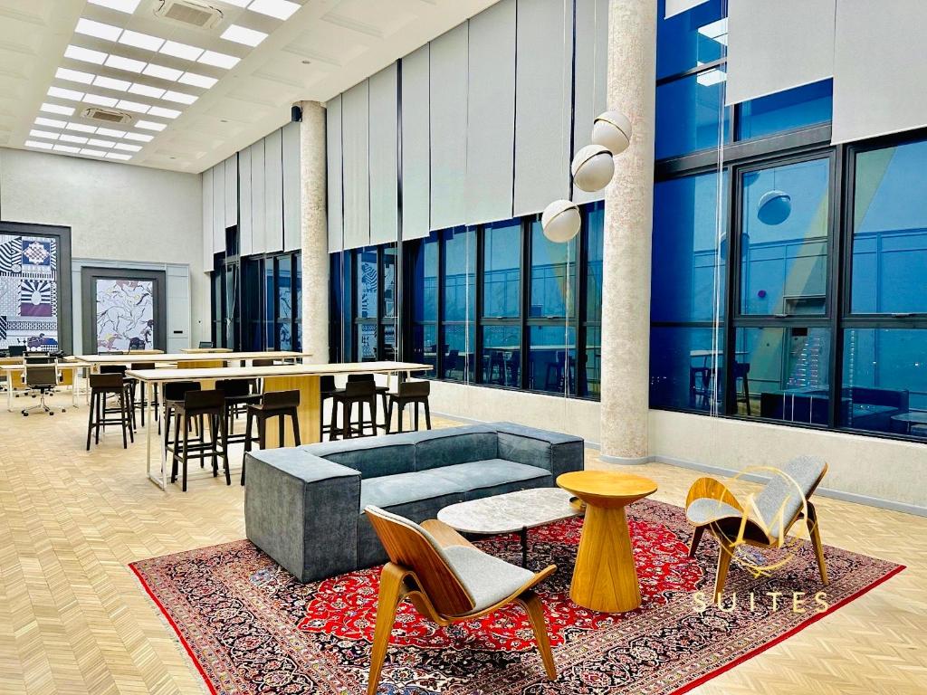 a lobby with chairs and tables in a building at Scarletz Suites KLCC by M Suites in Kuala Lumpur