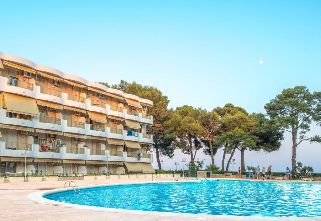 a swimming pool in front of a hotel at Ona Internacional Apartments in Cambrils