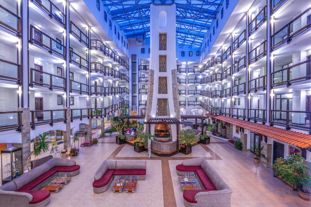 an image of a large building with a lobby at MPM Hotel Guinness in Bansko