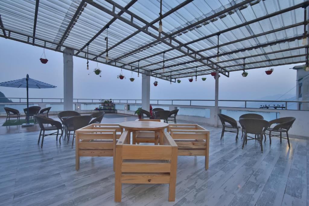 a room with tables and chairs in a building at Hotel Highland By DLS Hotels in Mussoorie