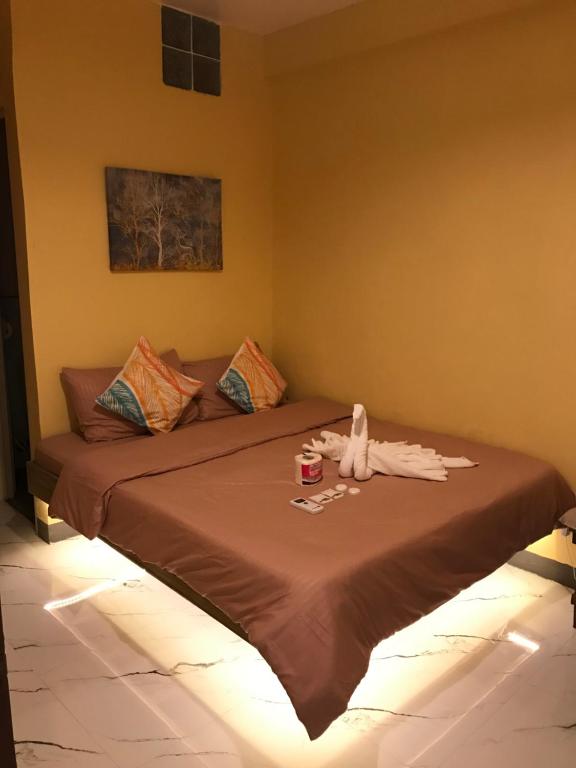 a bedroom with a bed with a drink on it at Elmo’s place in El Nido