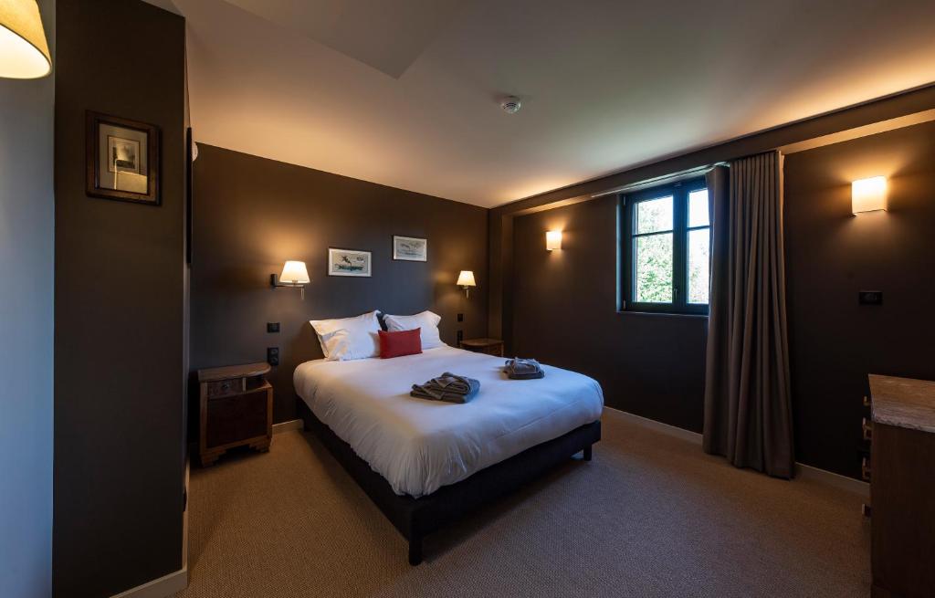 Postel nebo postele na pokoji v ubytování Hôtel du DOMAINE SAINT LOUP