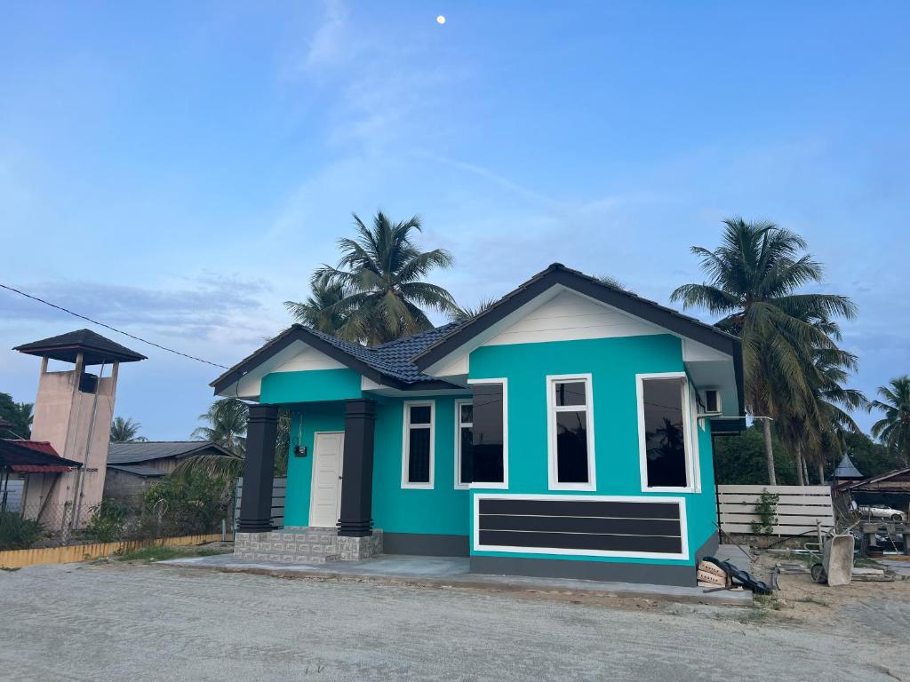 a small house with a blue at WAJA Homestay in Kampung Raja