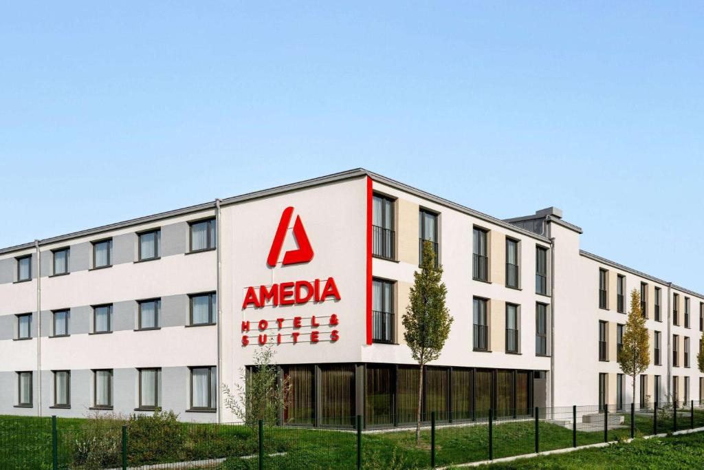 an office building with aania sign on it at Amedia Munich Dachau, Trademark Collection by Wyndham in Dachau