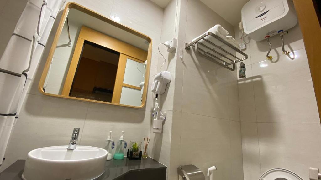 a bathroom with a sink and a mirror at Japanese Zen Room Citra Plaza Nagoya Batam in Nagoya