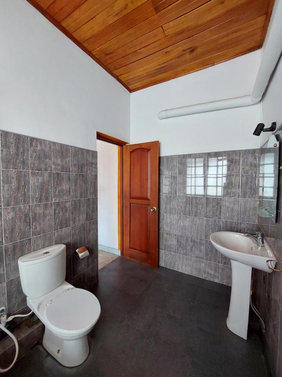 a bathroom with a toilet and a sink at Mystique Hideout in Kandy