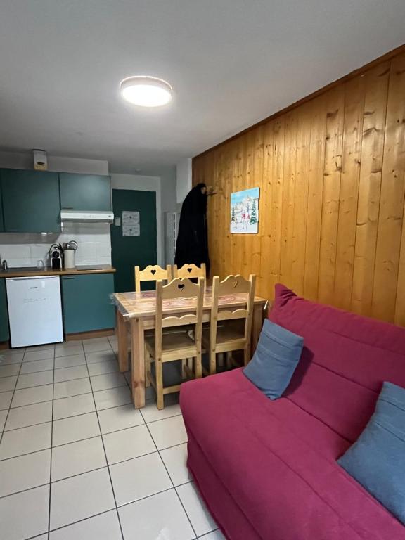 a kitchen and dining room with a table and a couch at L'Épicéa - Praz in Praz-sur-Arly
