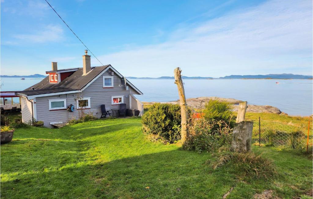 a house on a hill next to a body of water at 2 Bedroom Stunning Home In Rennesy in Hanasand