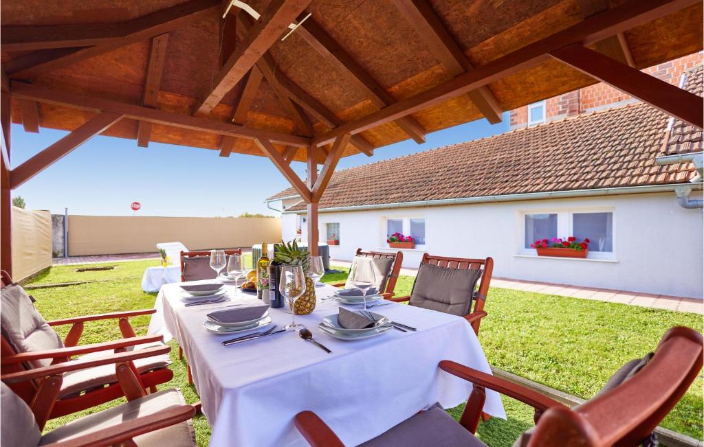 a long table with chairs and a white table cloth at 2 Bedroom Gorgeous Home In Zagreb in Zagreb