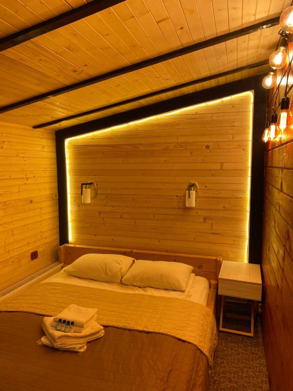 a bedroom with a bed with a light on it at Guest house Shulc in Mizhhirya