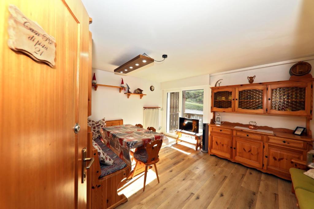 a kitchen with a table and a dining room at Casa a piè di pista in Tesero