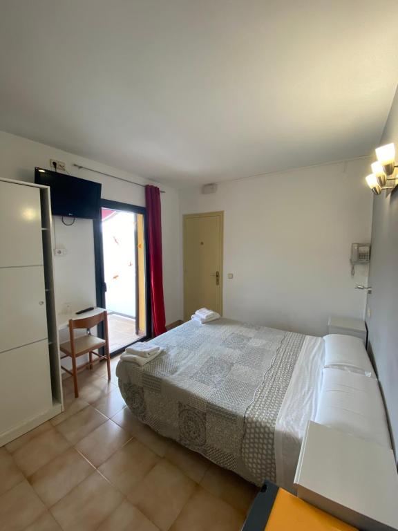 Postel nebo postele na pokoji v ubytování Hotel Les Roques