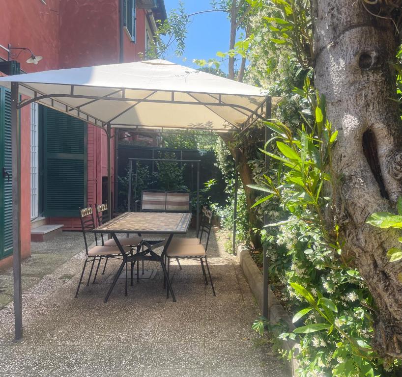 a table and chairs under an umbrella on a patio at Appia Park apartament Roma in Rome