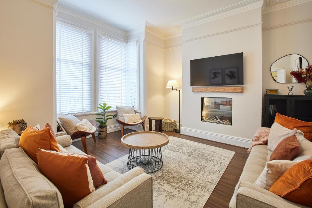 a living room with two couches and a fireplace at Host & Stay - Belle Vue in Saltburn-by-the-Sea