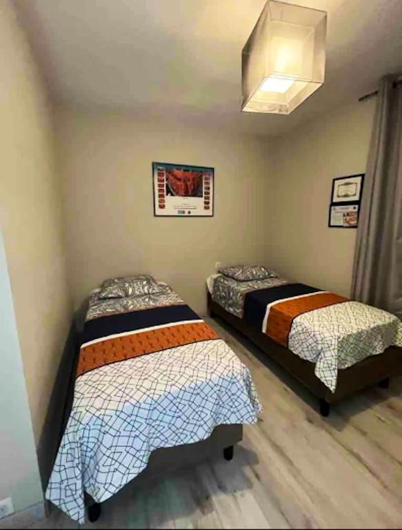 a bedroom with two beds and a window at Maison de 3 chambres a Valras Plage a 600 m de la plage avec spa jardin clos et wifi in Valras-Plage