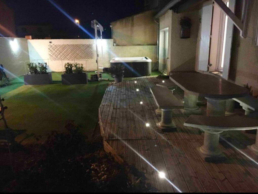 an empty patio at night with a fountain at Maison de 3 chambres a Valras Plage a 600 m de la plage avec spa jardin clos et wifi in Valras-Plage