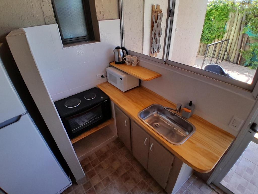 a small kitchen with a sink and a stove at PATO BLANCO in Ciudad Lujan de Cuyo