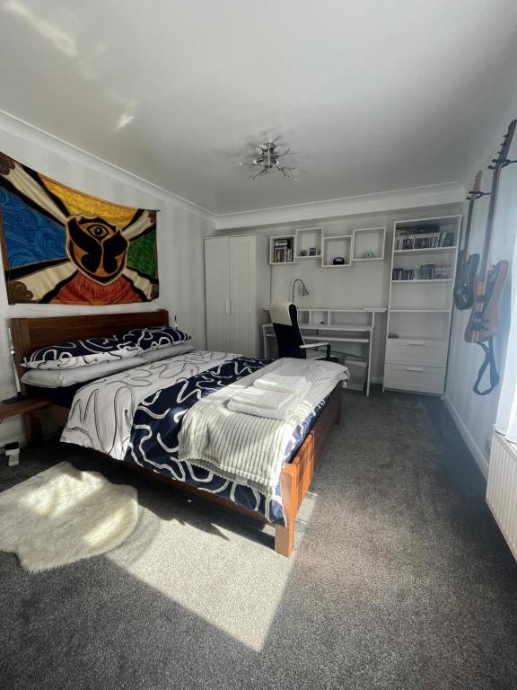 a bedroom with a large bed and a desk at Private Flat in City Centre with Parking in Southampton