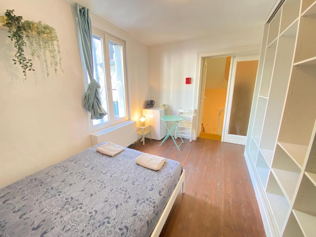 a bedroom with a bed with two towels on it at Charming National Street Room in the Heart of Antwerp in Antwerp