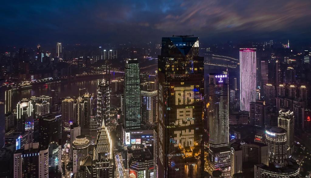 a view of a city at night at The Lixury Hotel, in The Unbound Collection by Hyatt in Chongqing