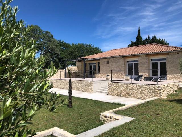 a stone house with a porch and a patio at Villa en Provence in Bollène