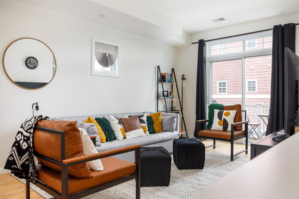 a living room with a couch and two chairs at Midtown Modern - urban condo walkable to bars and beach in Traverse City