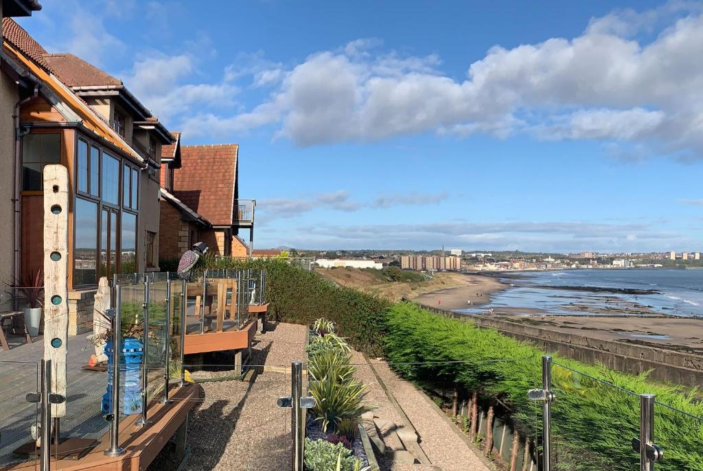 a balcony with a view of the ocean and a beach at Luxury Seaside Home with Incredible Views in Fife