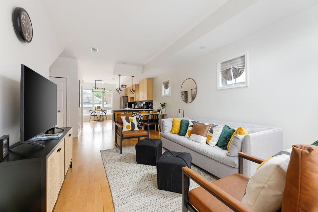 a living room with a couch and a tv at Midtown Modern - urban condo walkable to bars and beach in Traverse City