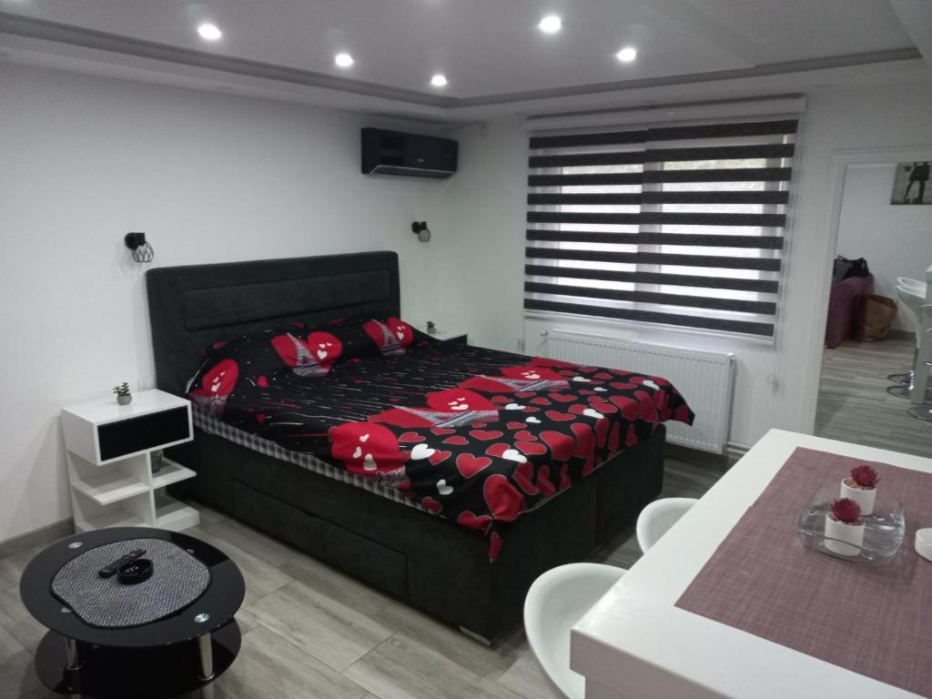 a bedroom with a bed and a table and chairs at Adrijana 2 Apartmani in Vrnjačka Banja