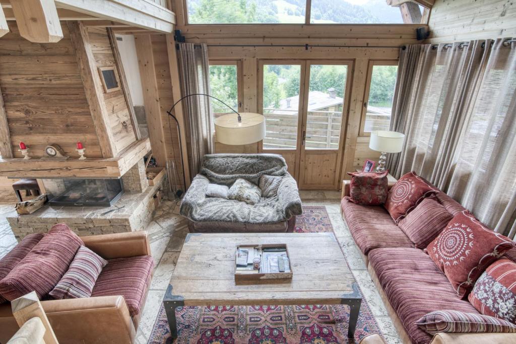 a living room with a couch and a table at Chalet luxe MARTA in Saint-Laurent-de-Mure