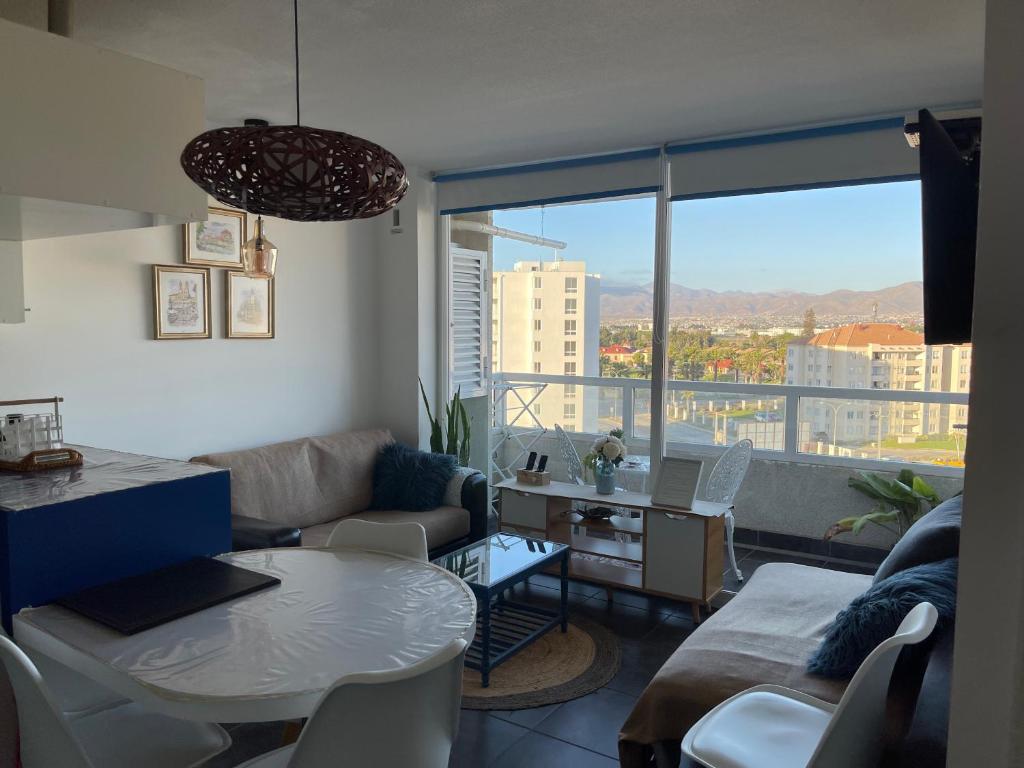 a living room with a couch and a table at Playa Blanca in La Serena