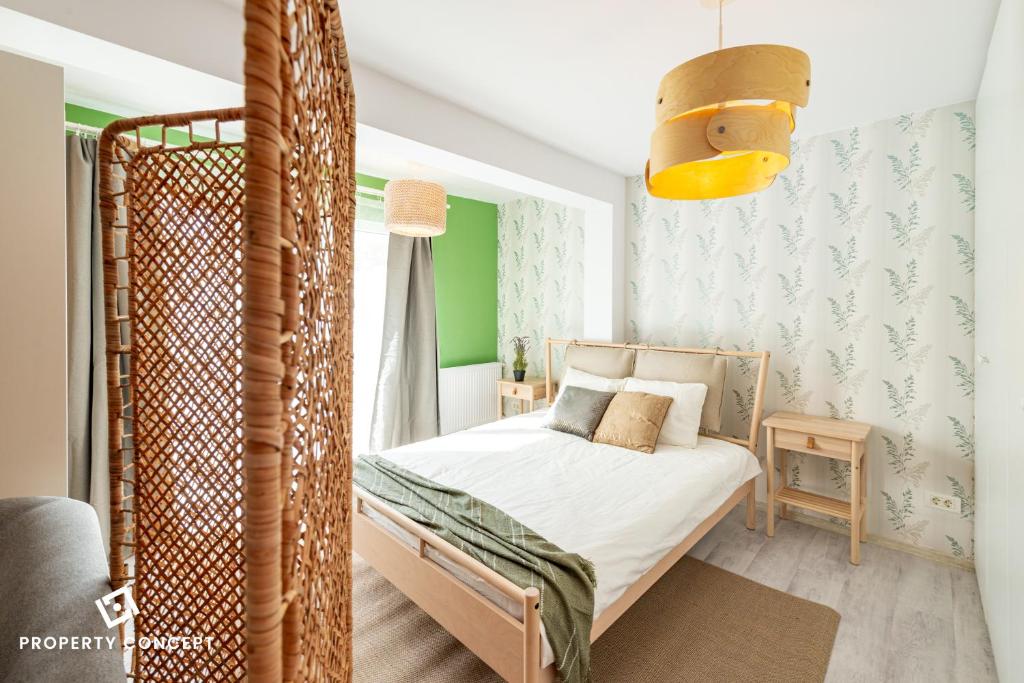a small bedroom with a bed and a green wall at New Residence Concept Studio in Roşu