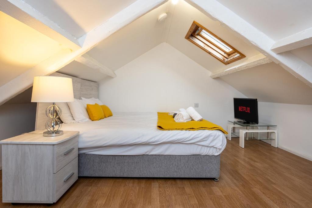a bedroom with a bed in a attic at Neath road -Flat 3 in Swansea