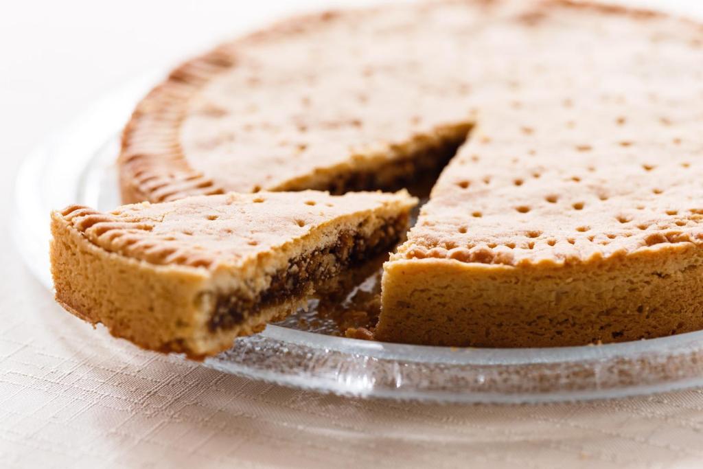 a piece of pie on a glass plate with a slice missing at Hauser Hotel St. Moritz in St. Moritz