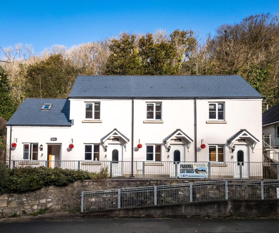 a white house with a black roof at Tor Bay Cottage - 1 Bedroom - Parkmill in Parkmill