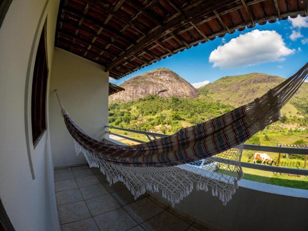 a hammock in a room with a view of mountains at Apt Flat 225 Condomínio Pedra do Rodeadouro in Bonito