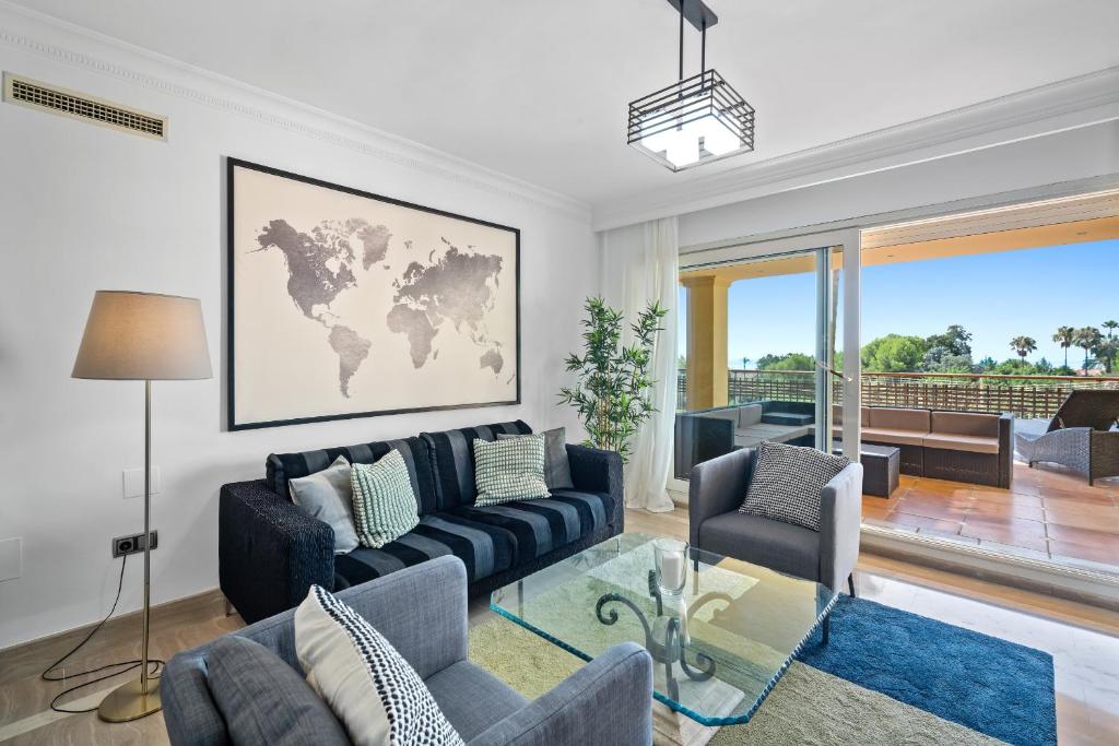 a living room with a couch and a map on the wall at Sierra Blanca in Marbella