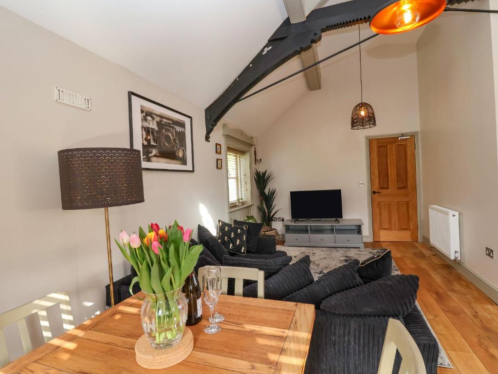 a living room with a table and a couch at The Arms House in Telford