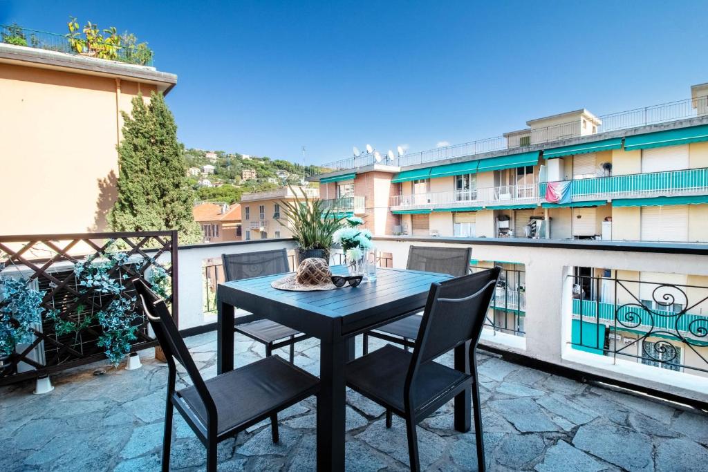 a black table and chairs on a balcony at Daisy by PortofinoHomes in Santa Margherita Ligure