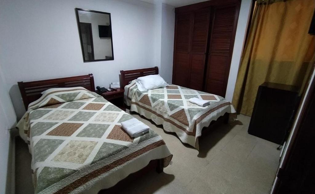 Postel nebo postele na pokoji v ubytování Hotel Tarento Suite