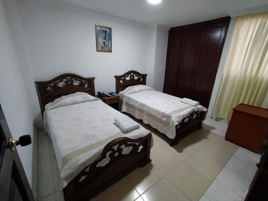Postel nebo postele na pokoji v ubytování Hotel Tarento Suite