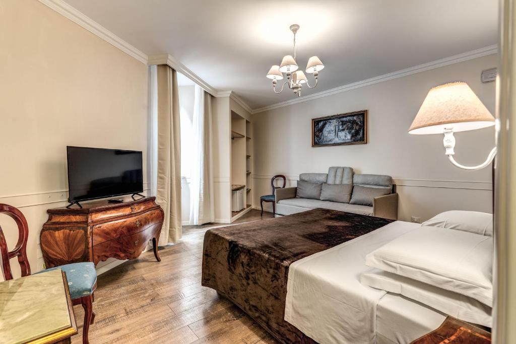 a bedroom with a bed and a tv and a couch at Aurelius Ponte Sant'Angelo in Rome