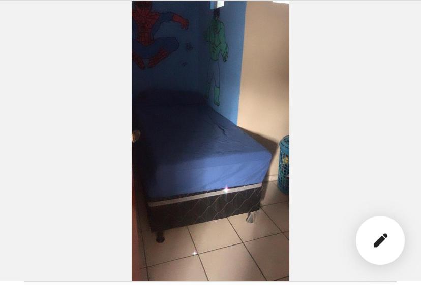 a small bedroom with a blue bed in a room at Apê da VAN acomoda até 7 pessoas in Garanhuns
