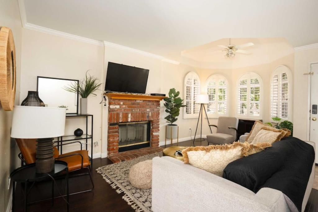 a living room with a couch and a fireplace at Charming 4BR Retreat - Near Old Town Monrovia in Monrovia