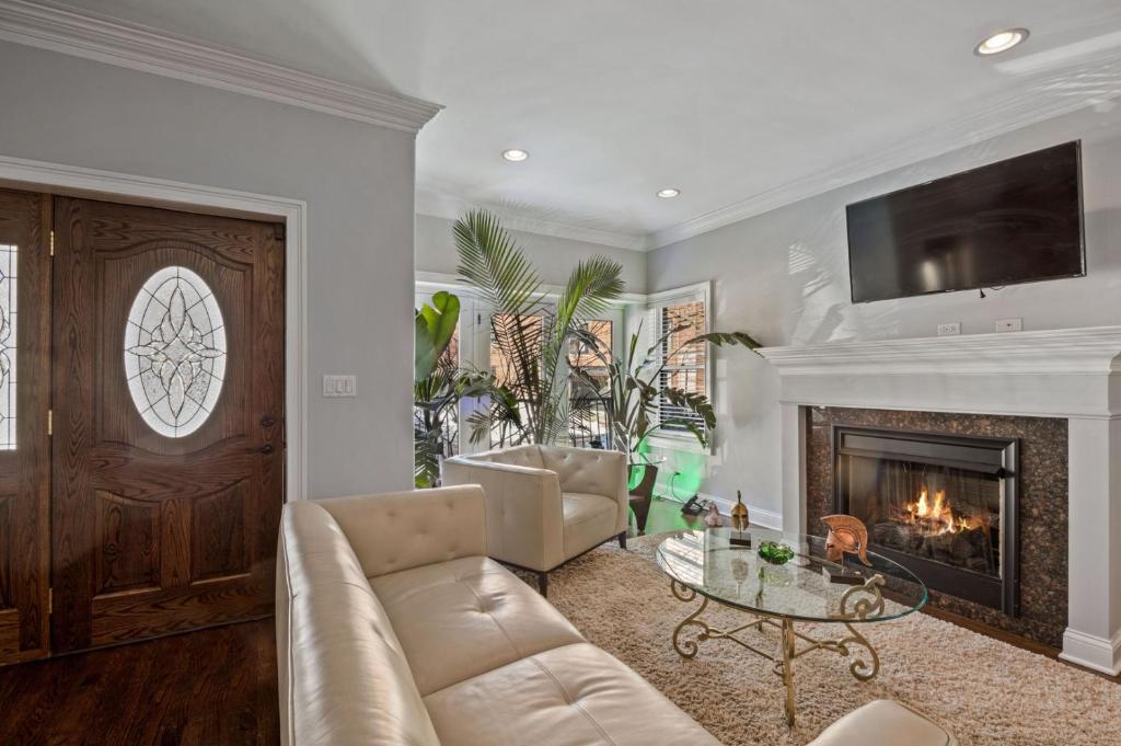 a living room with a couch and a fireplace at Luxury Home near Wrigley, Boystown & Andersonville in Chicago