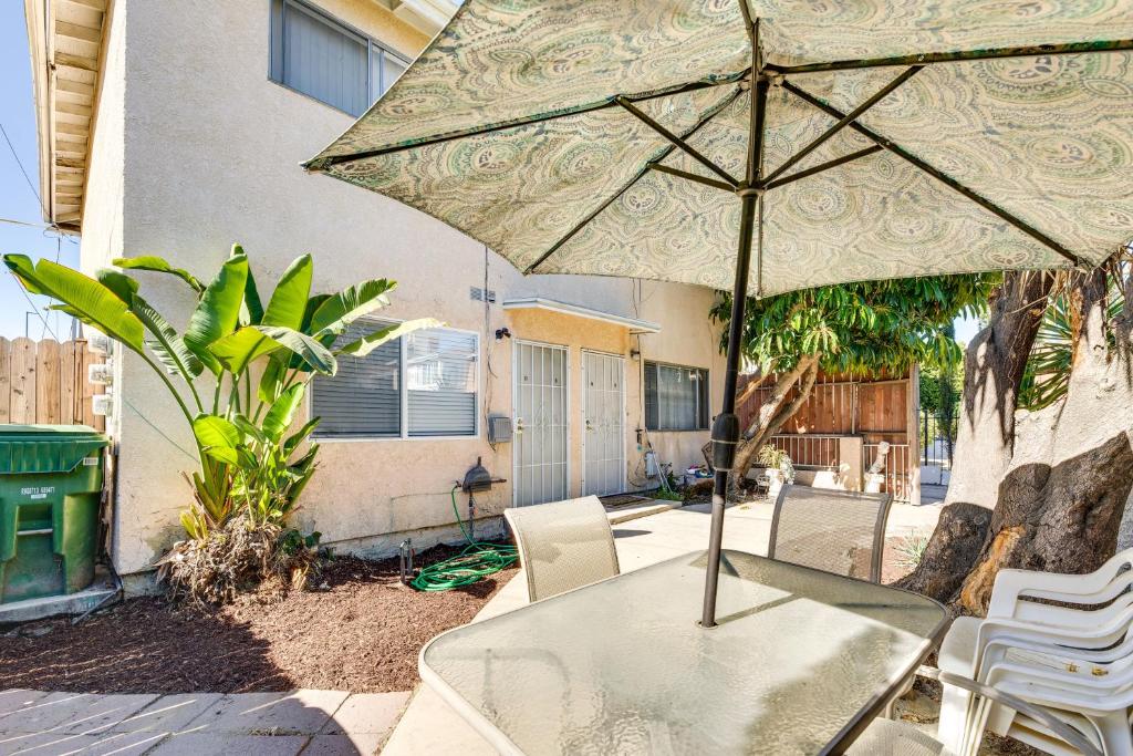 a table with an umbrella on a patio at North Hollywood Home about 3 Mi to Universal Studios! in North Hollywood